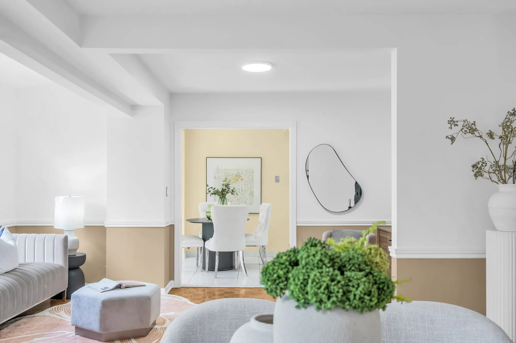 Through a vase of greenery to the sitting area and the breakfast room beyond