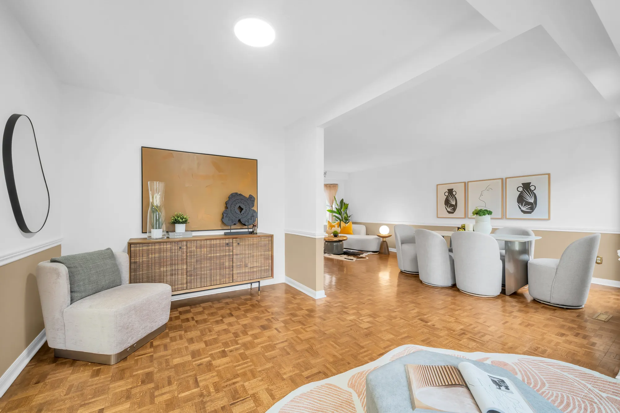 From the sitting area to the dining table, an armchair and a wood sideboard, the living room beyond